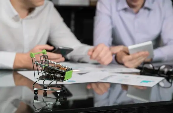 Men's hands with calculator and phone on the background of the documents on the table